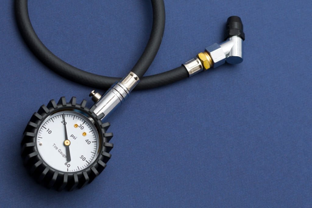 What are the benefits of using a tire pressure gauge for a truck?